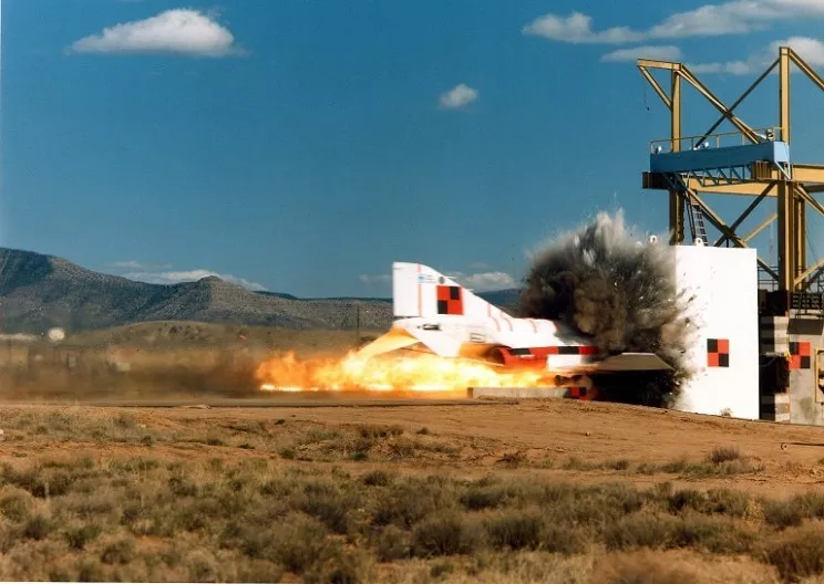 An experiment tested the strength of reinforced concrete by firing an F-4 Phantom jet at a massive concrete wall at 770 kilometers per hour, assessing a nuclear power plant's ability to withstand a terrorist attack. | Credit: Sandia Laboratories